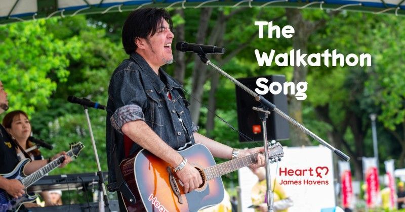James Havens performing outdoors with guitar beside text The Walkathon Song