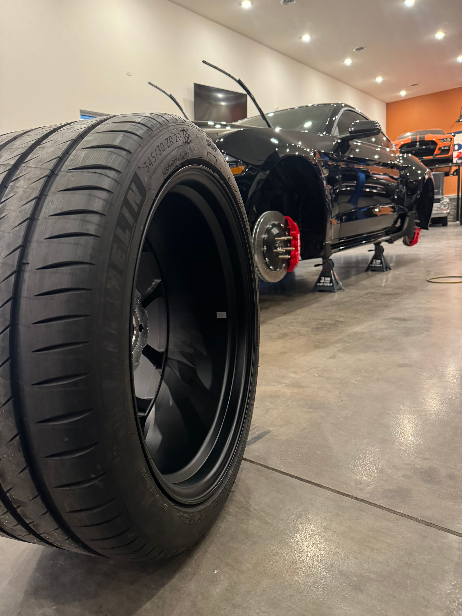 A close up of a tire on a car in a garage
