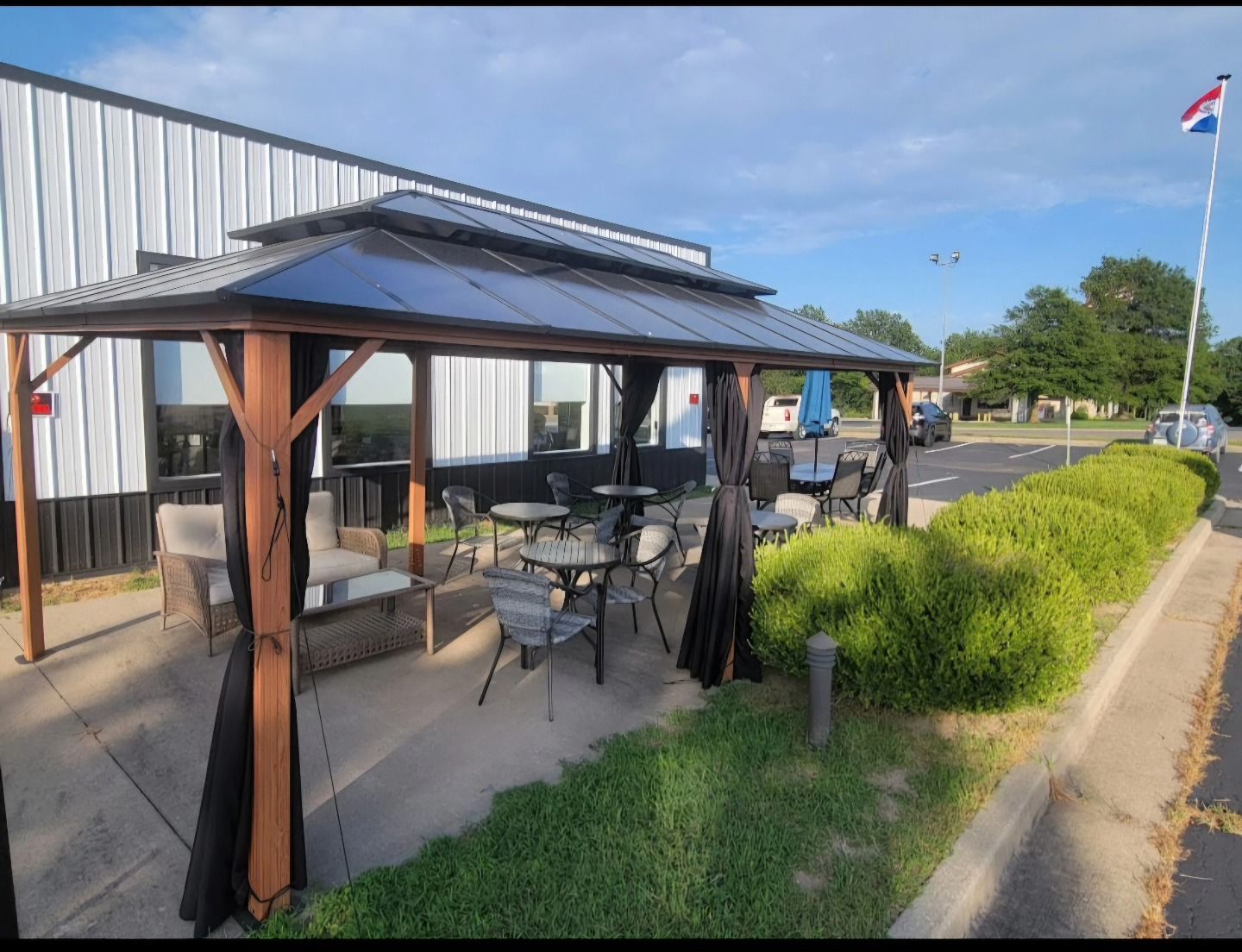 covered patio with chairs and tables