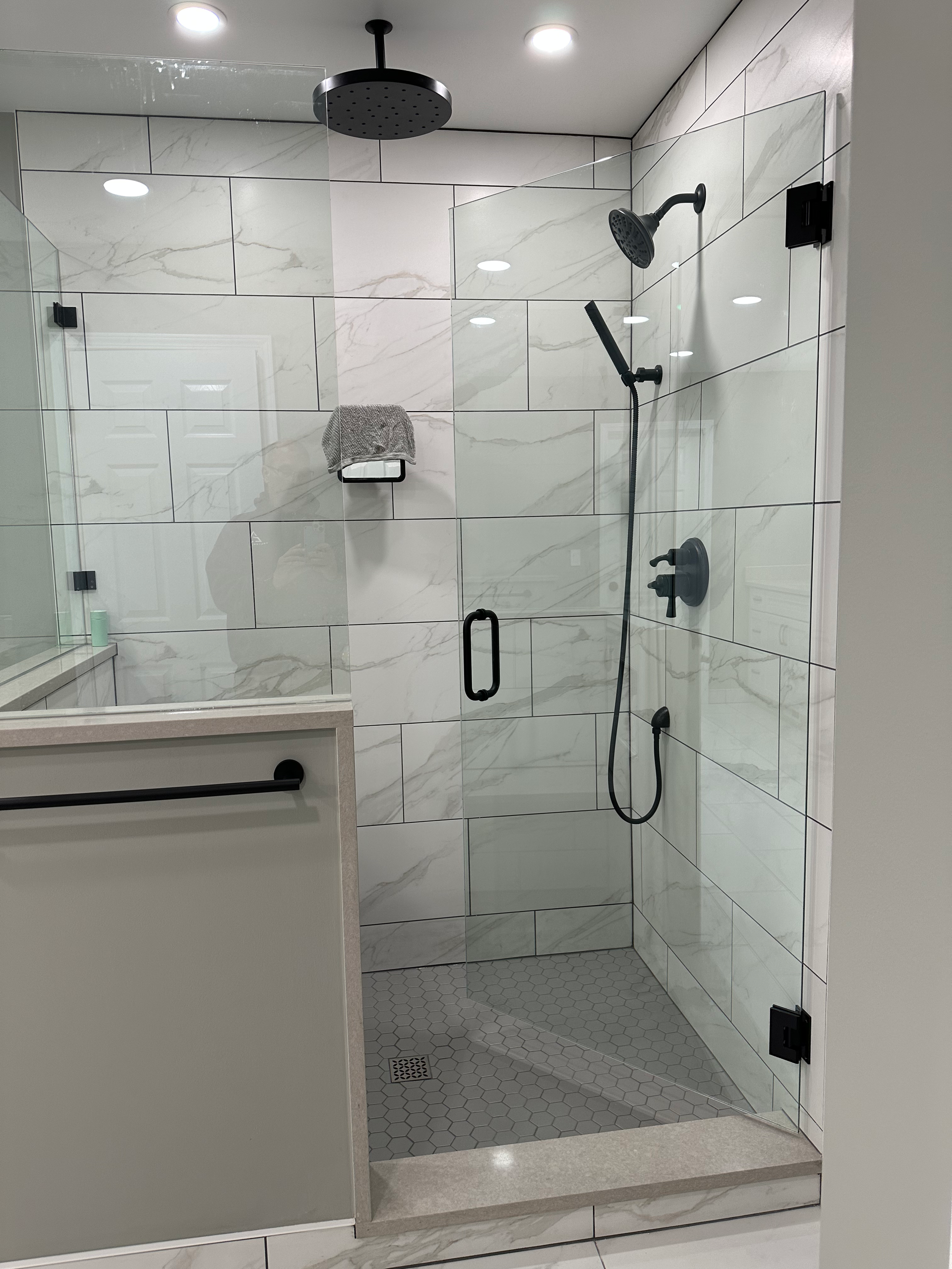 A bathroom with a toilet , sink and mirror.