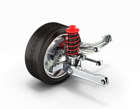 A car suspension with a shock absorber and a tire on a white background.