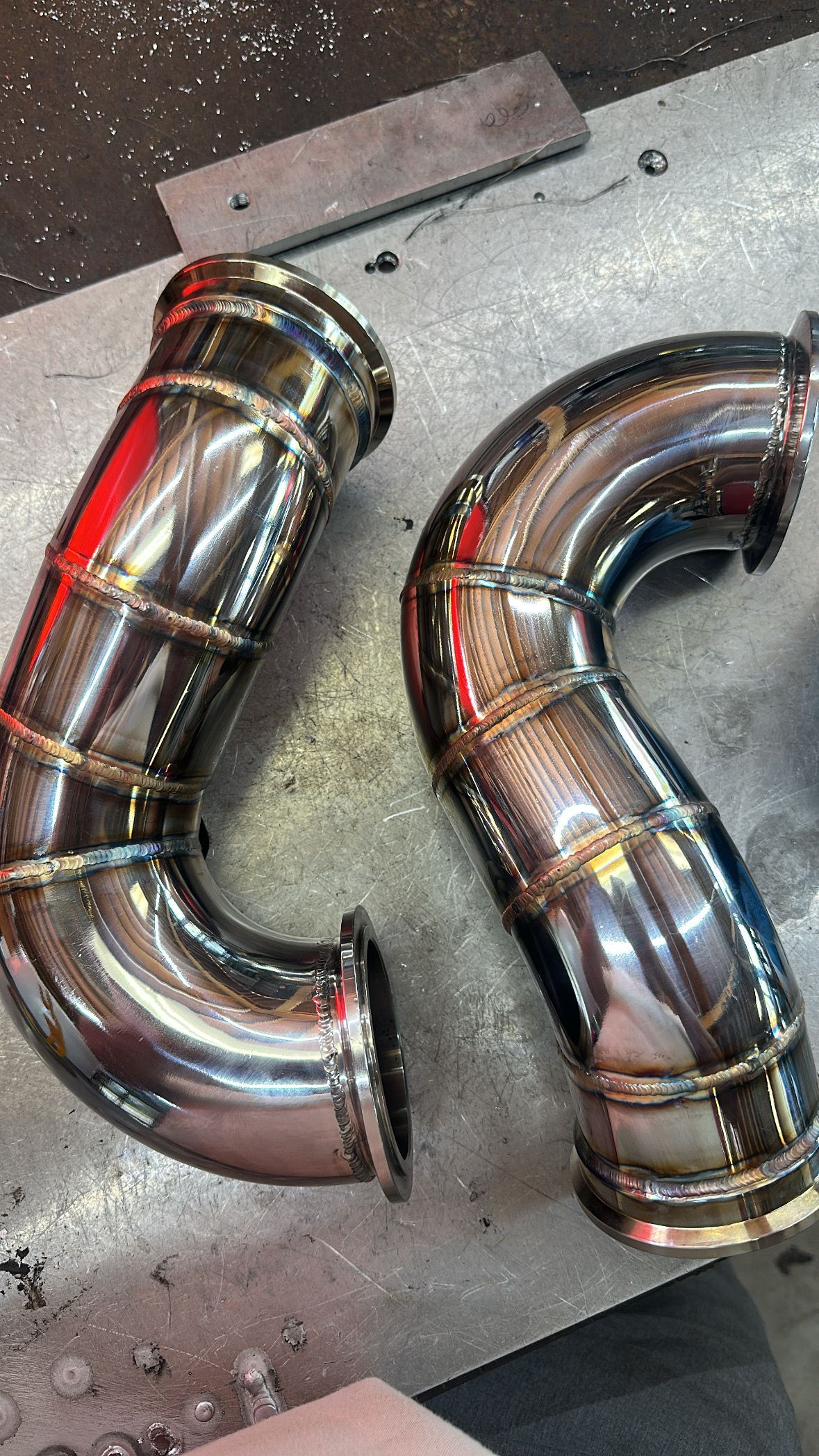 A pair of stainless steel pipes sitting on top of a table.