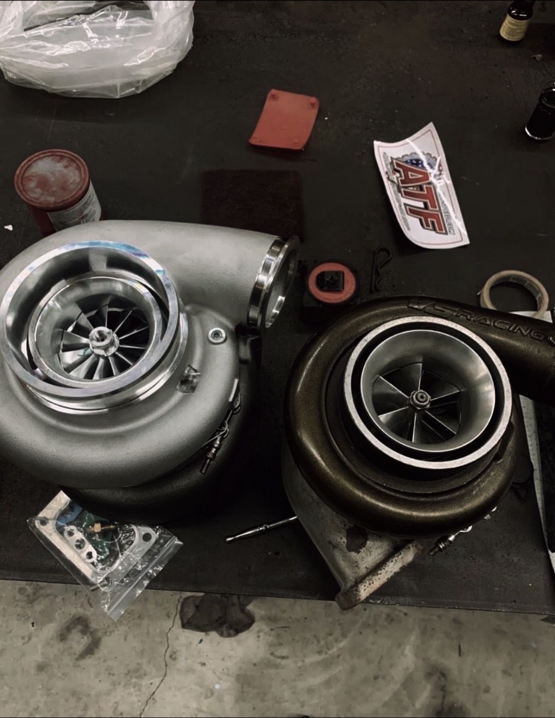 Two turbochargers are sitting next to each other on a table