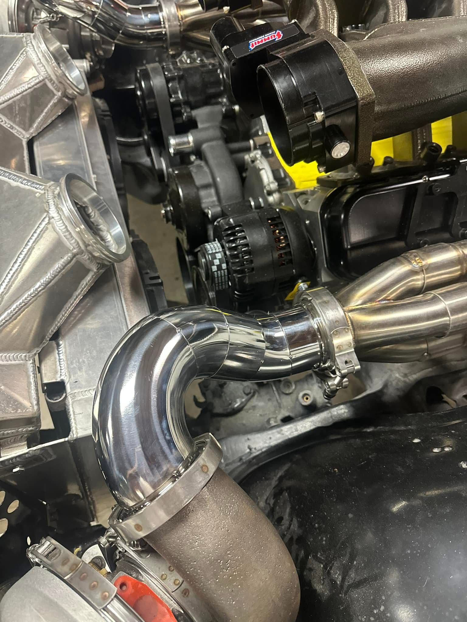 A close up of a turbocharger on a car engine.