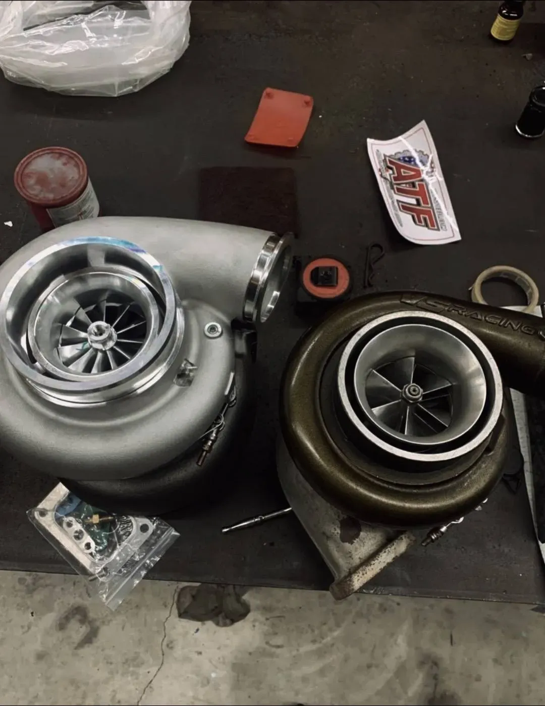 Two turbochargers are sitting next to each other on a table
