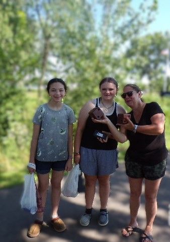 Three people smiling outdoors, just had some GamGams Chocolate.
