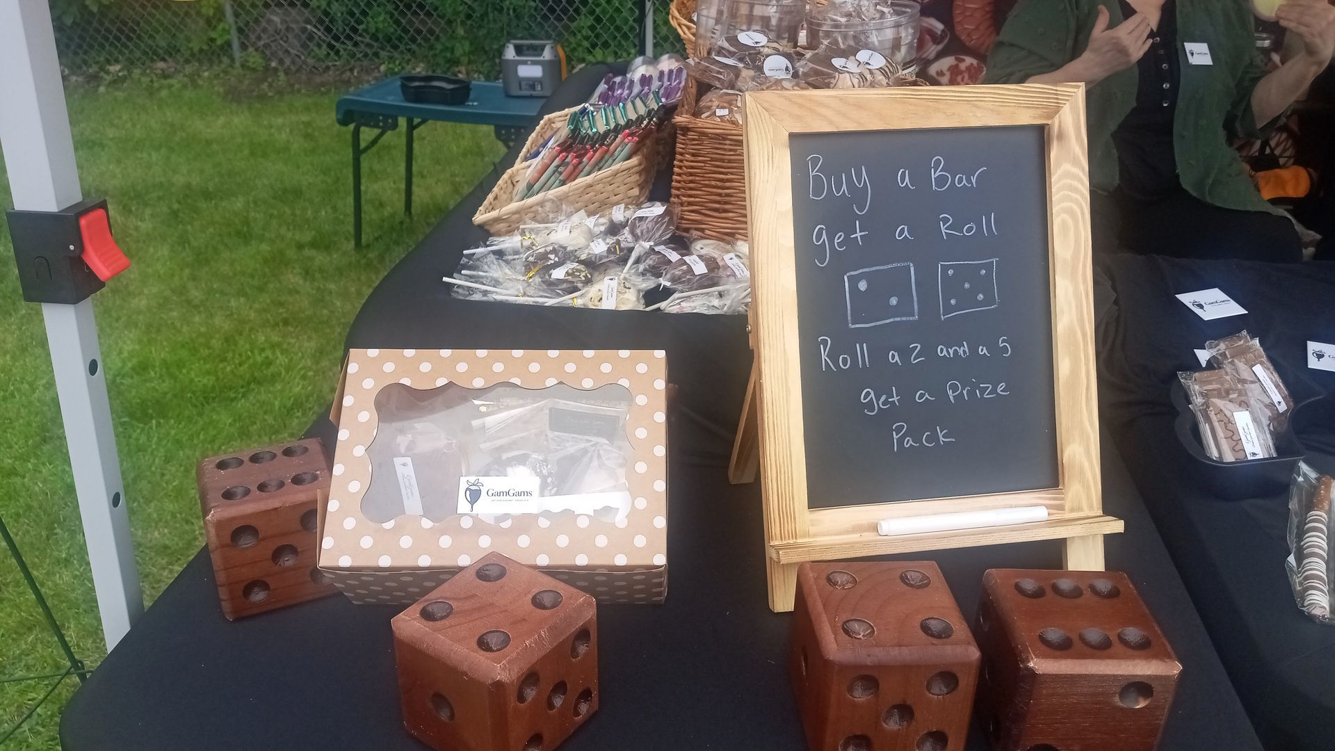 A food stall with wooden dice. Sign says, 