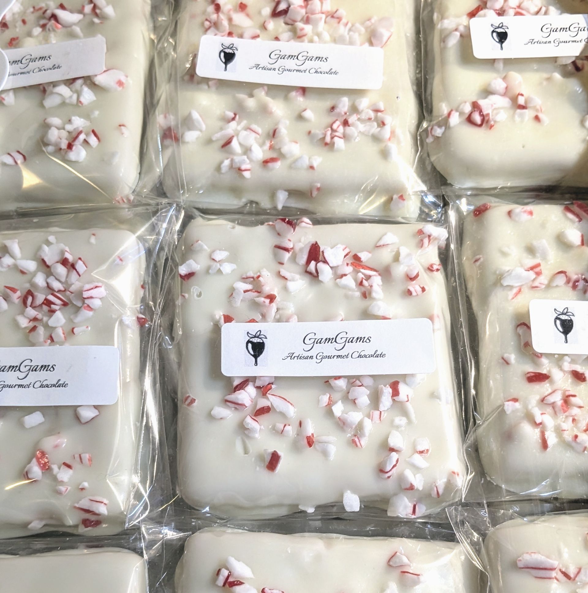White chocolate bark, sprinkled with crushed peppermint, packaged.