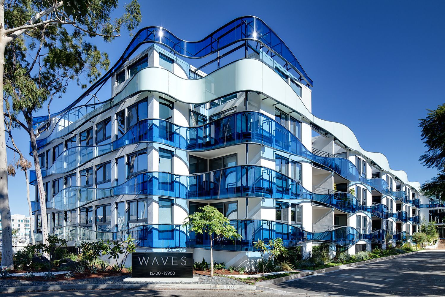 a large blue and white building with a sign that says waves