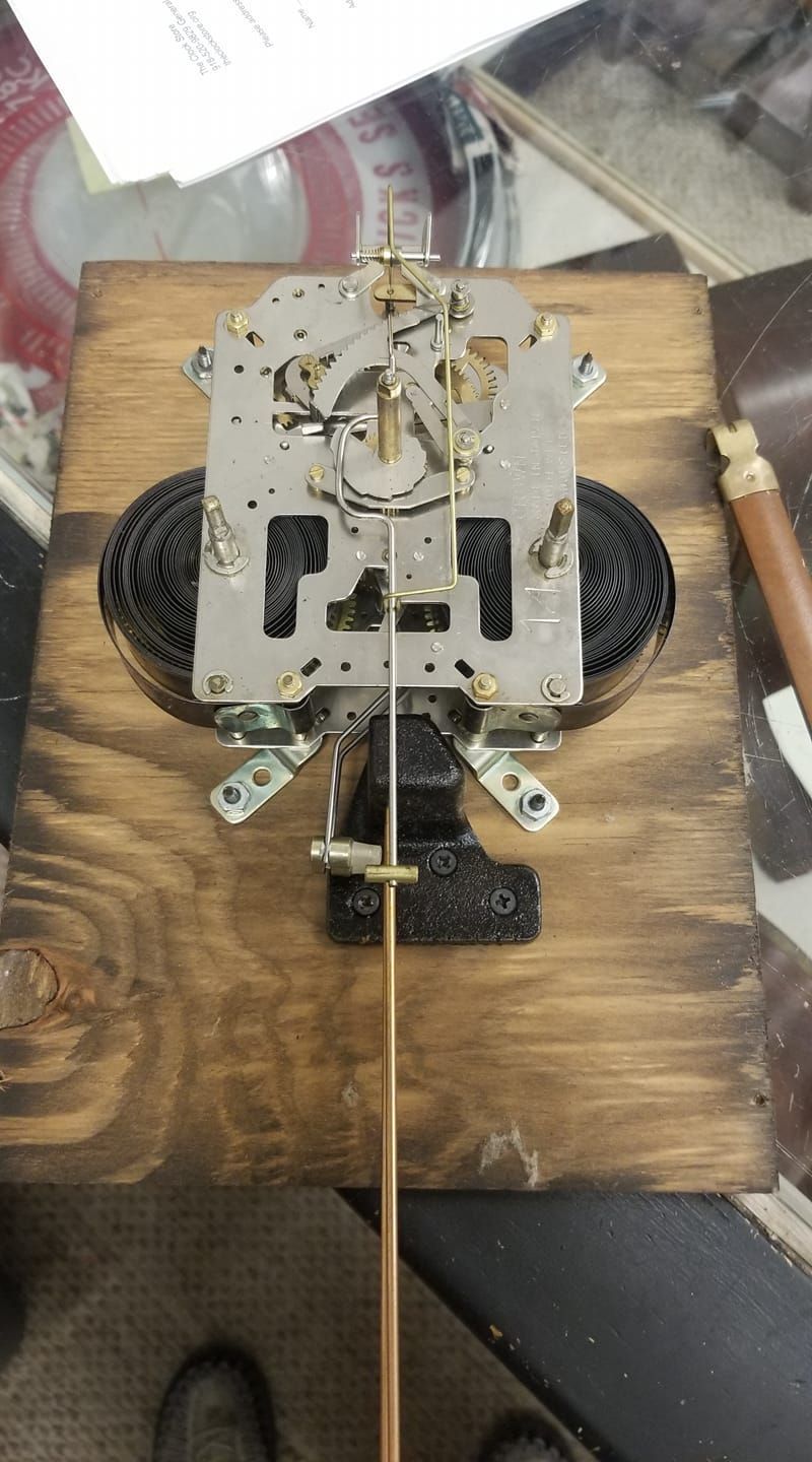 A clock is sitting on top of a wooden table.