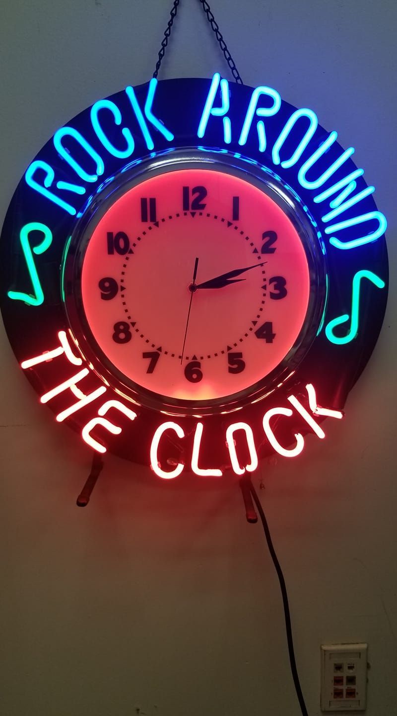 A neon sign that says rock around the clock