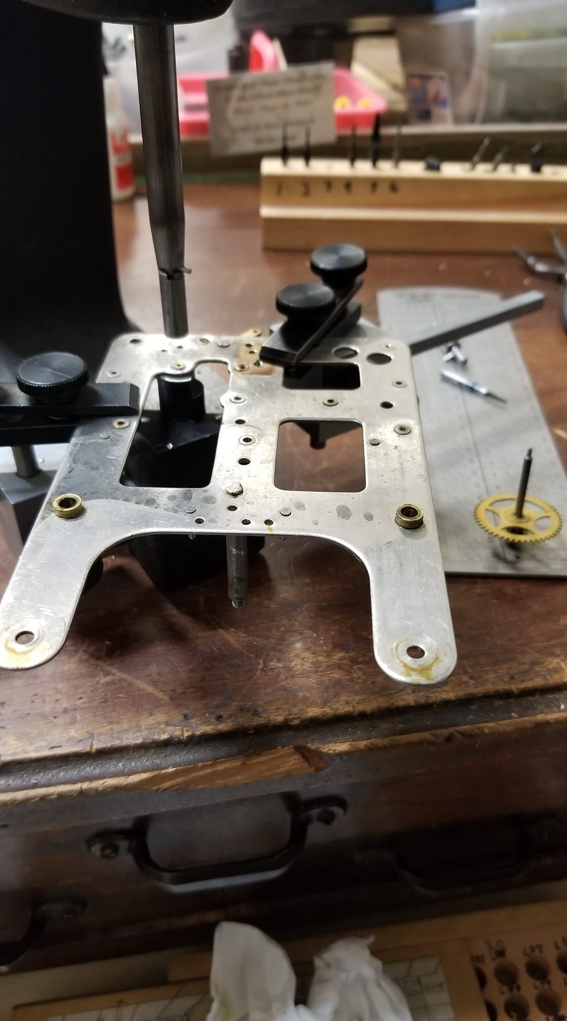 A piece of metal is sitting on top of a wooden table.