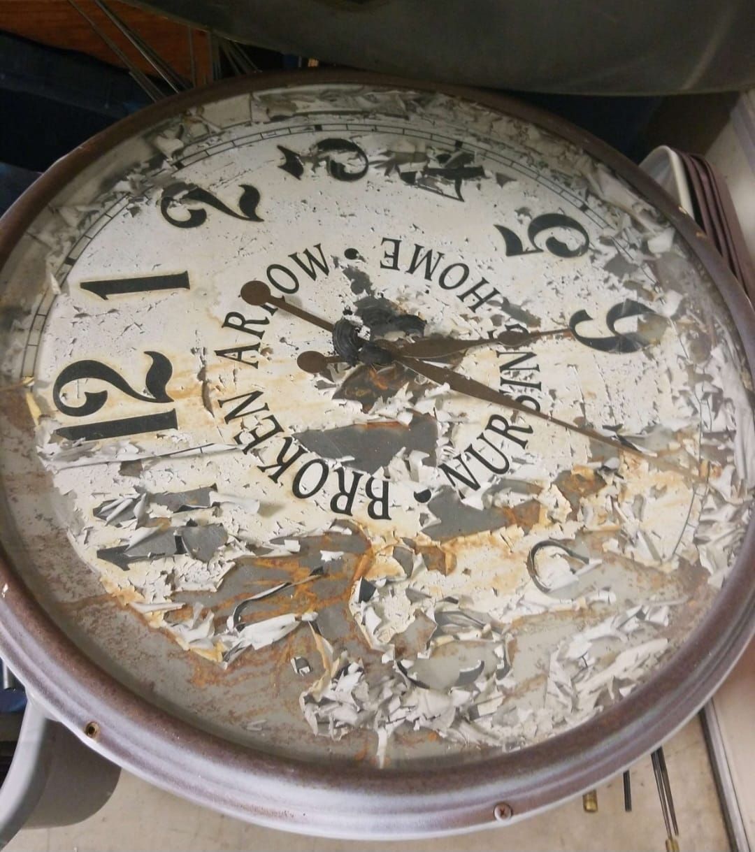 A broken clock that says home on it