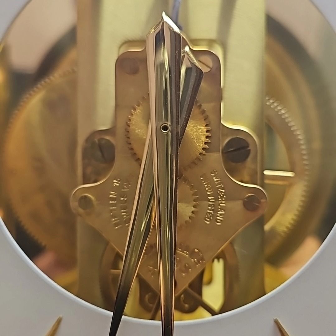 A close up of the inside of a gold clock