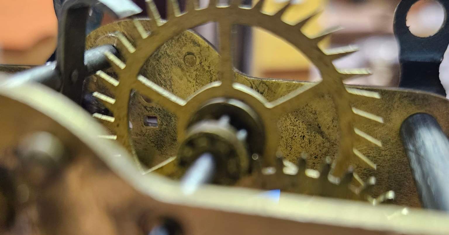 A close up of the inside of a clock.