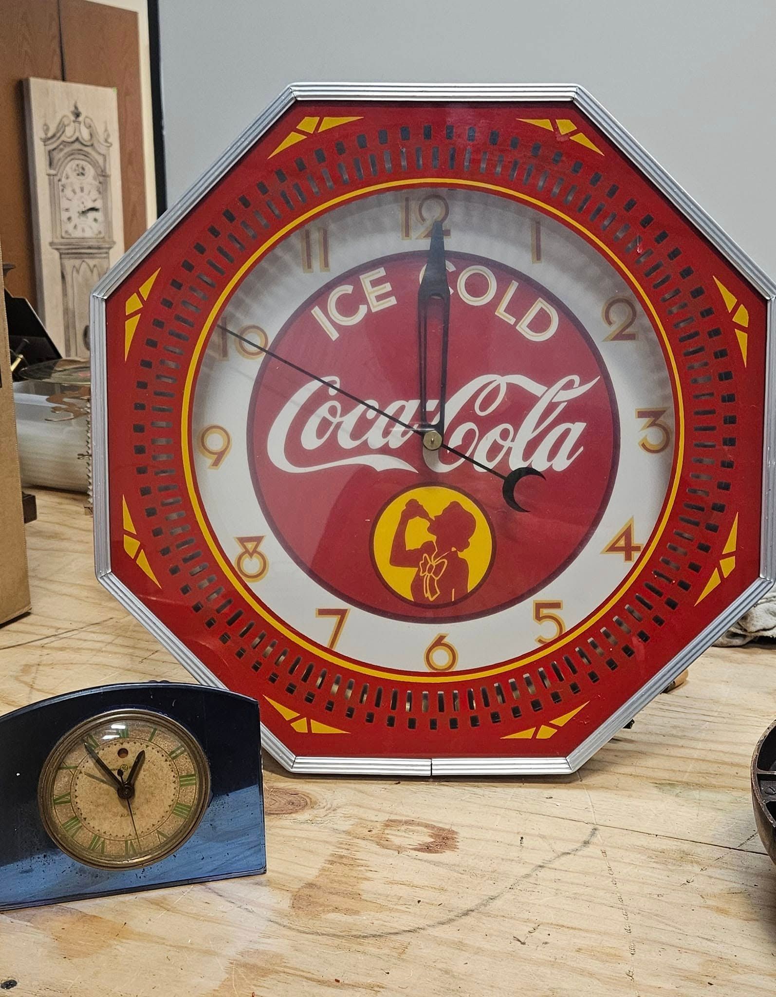 A clock that says ice cold coca cola on it