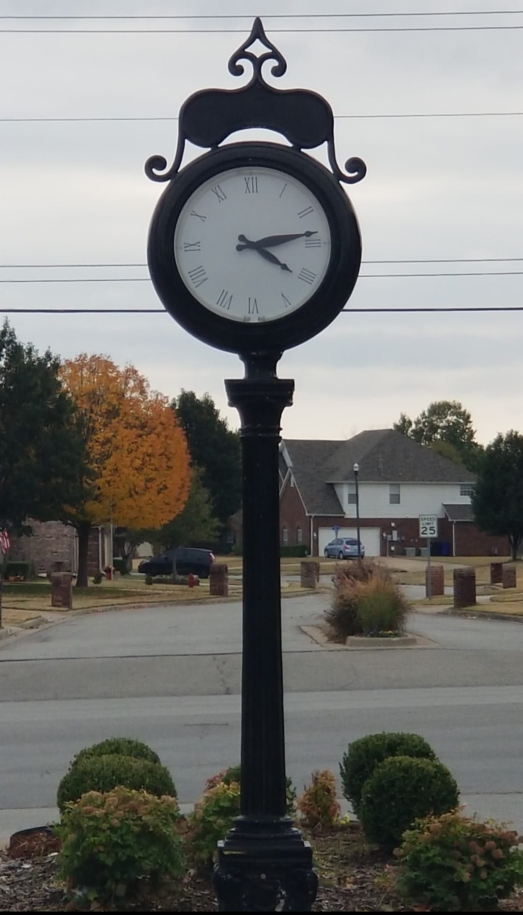A clock on a pole shows the time as 4:20