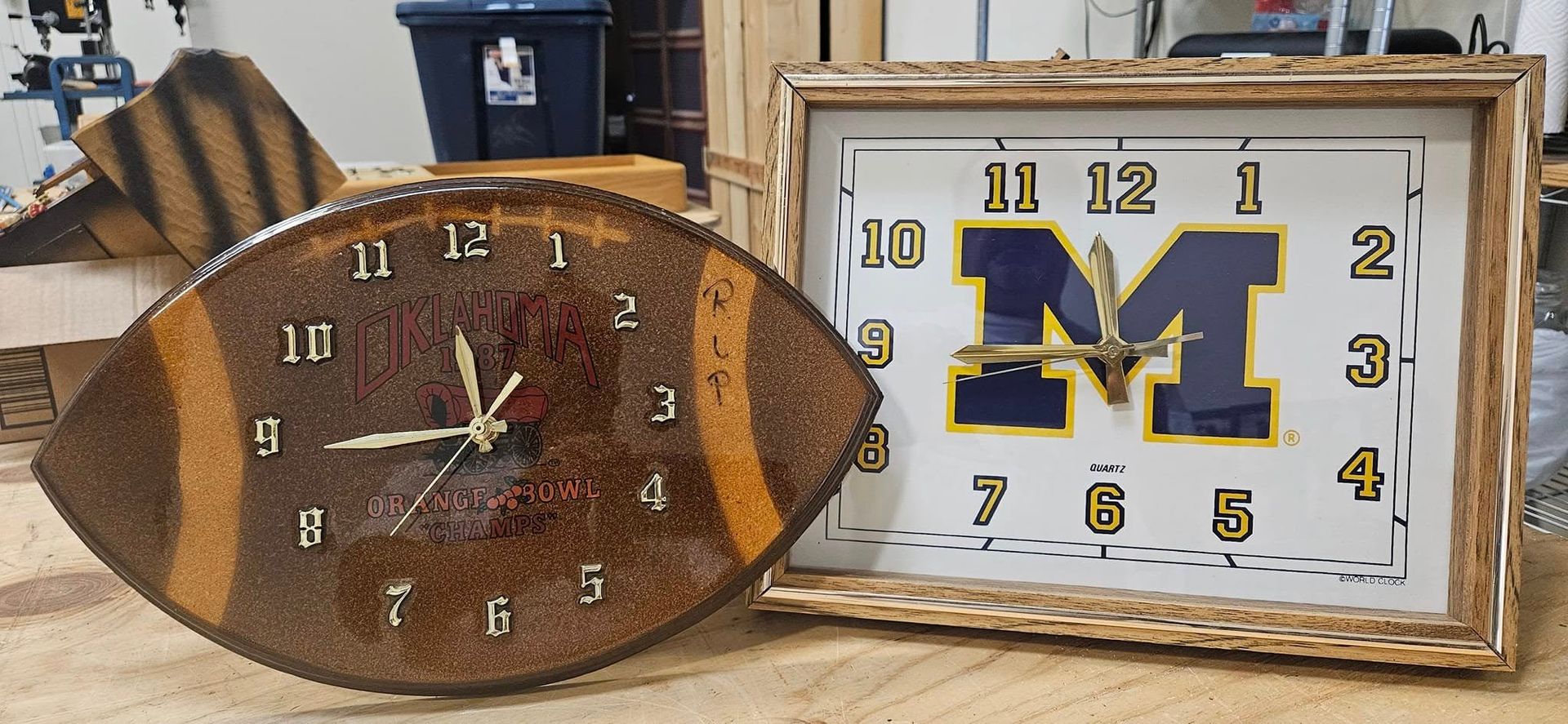 Two clocks one of which has the letter m on it