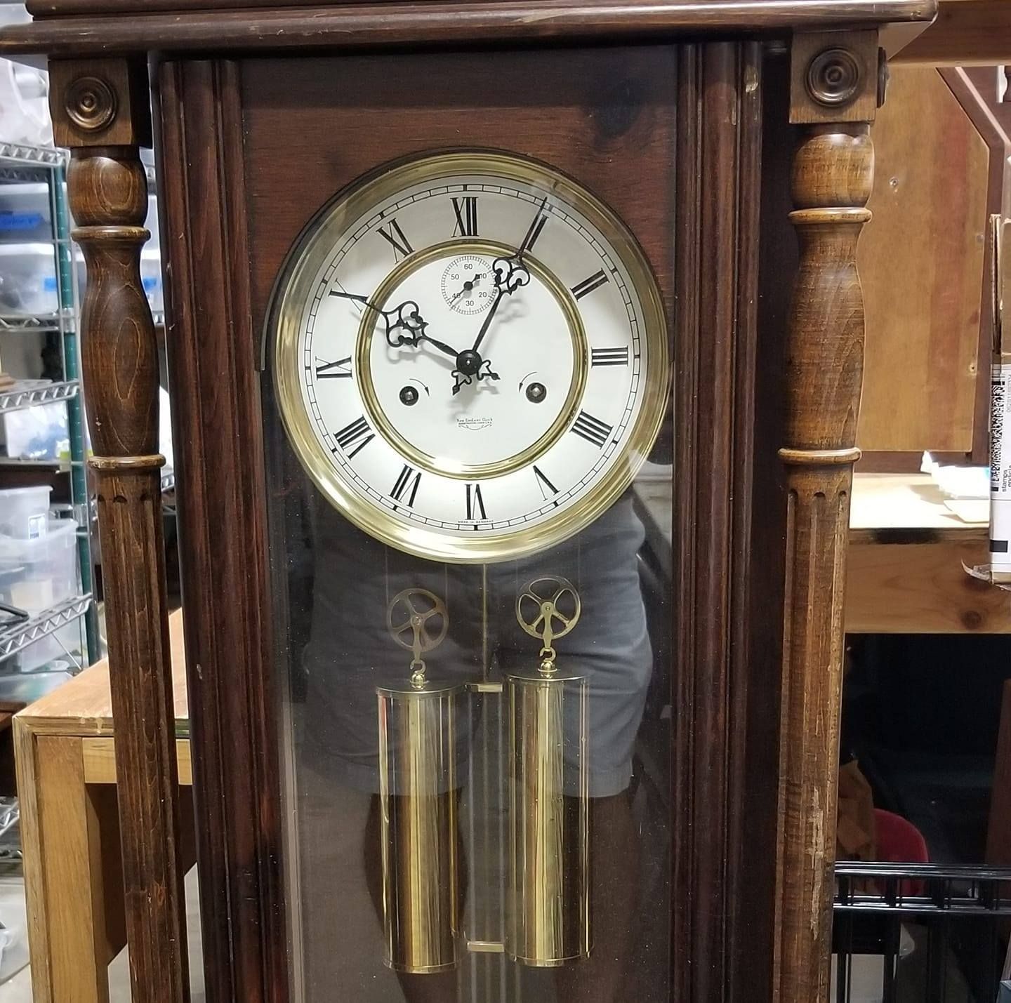 A wooden clock with roman numerals on the face