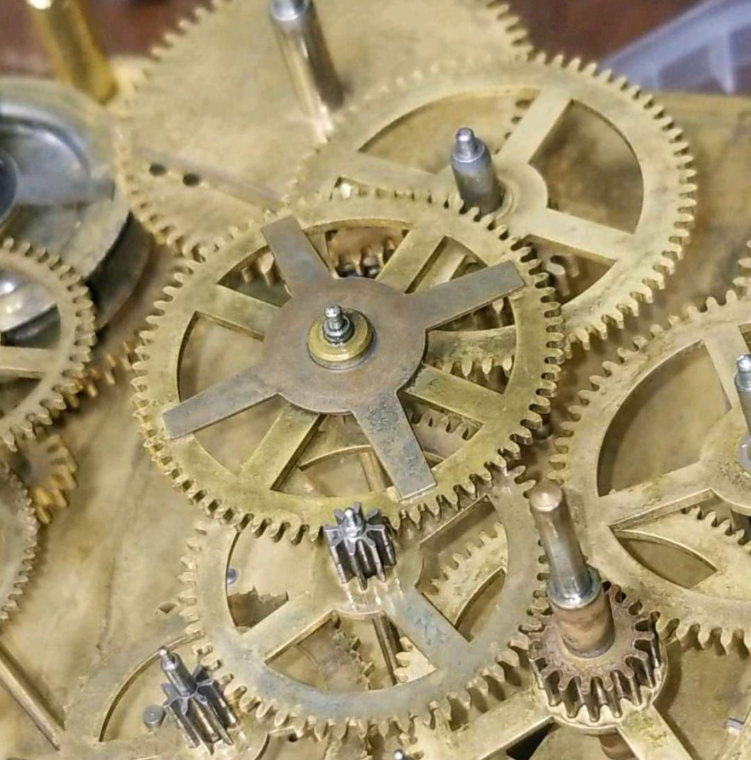 A close up of the inside of a clock with gears