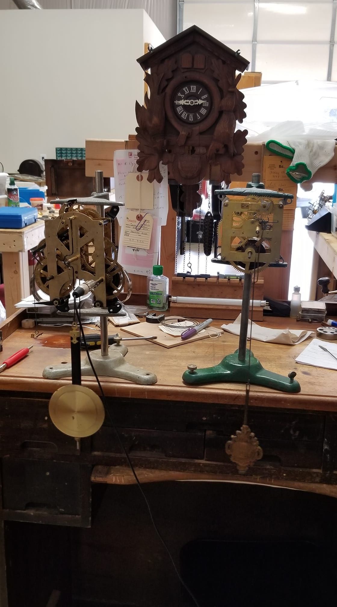 A cuckoo clock is sitting on top of a wooden table.