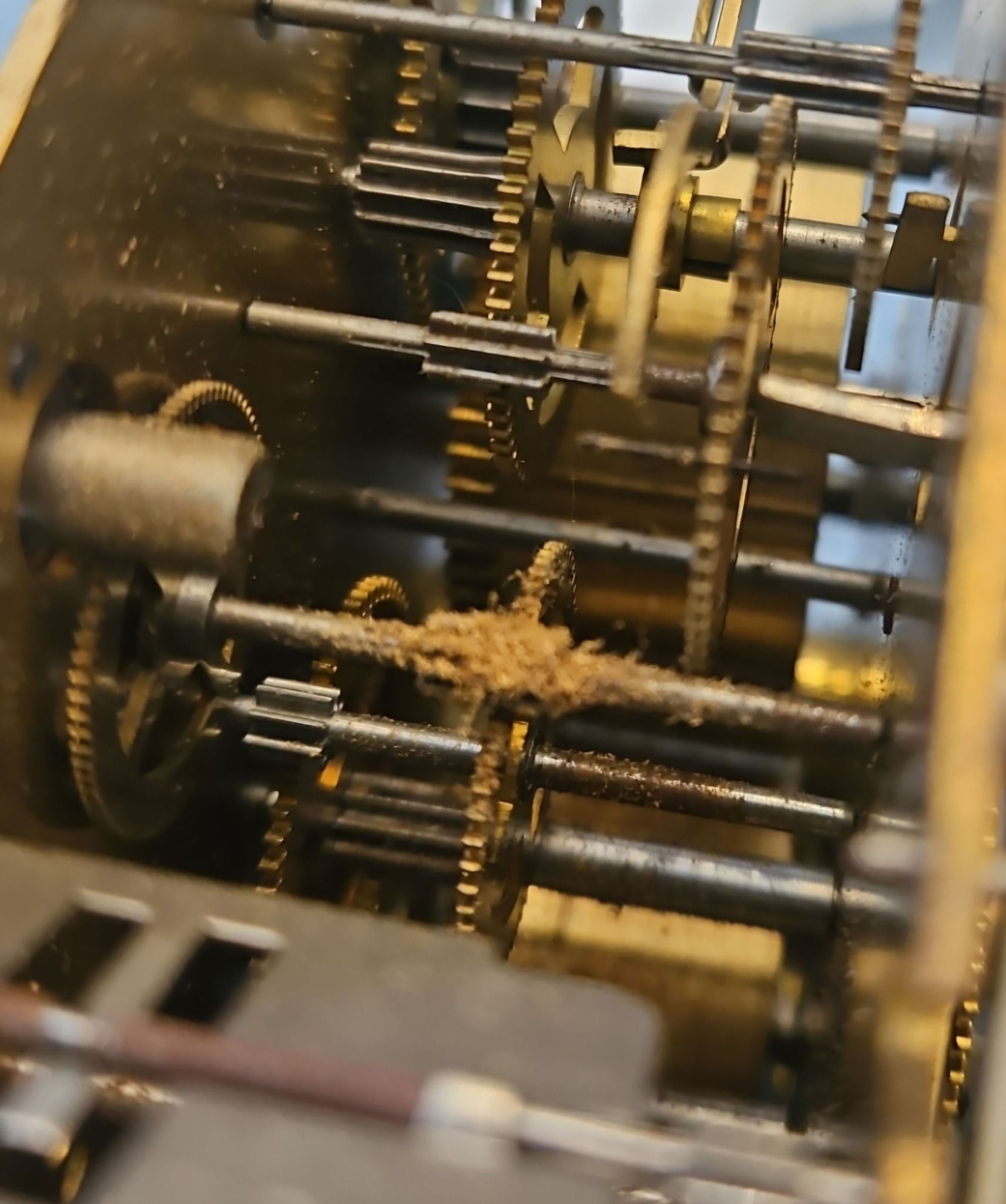 A close up of the inside of a clock mechanism