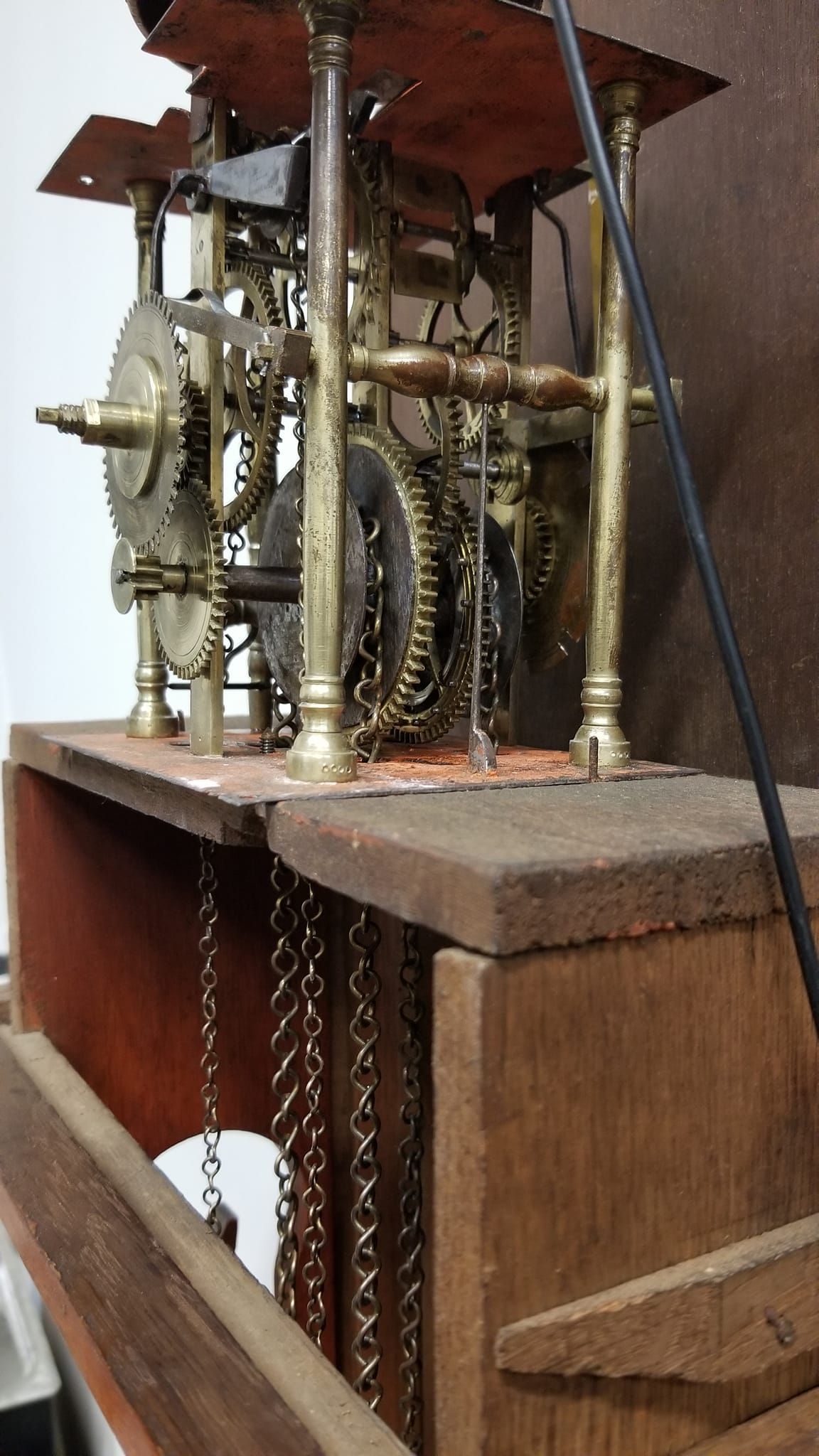 A clock is sitting on top of a wooden box.