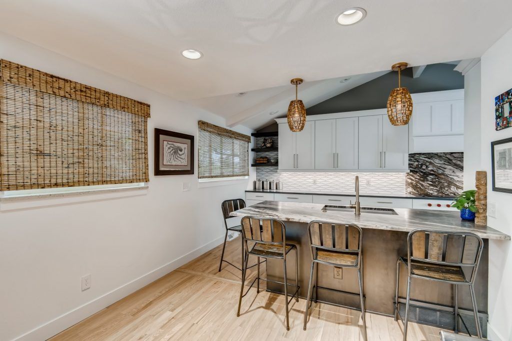 A kitchen with a large island and stools