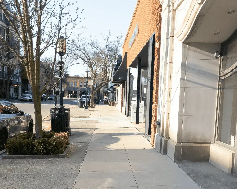 A sidewalk between two buildings in a small town