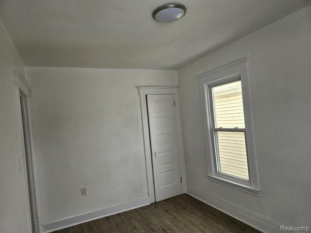 An empty room with a window and a door.
