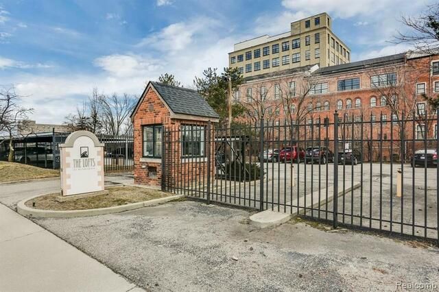 A brick building with a gate and a fence in front of it.