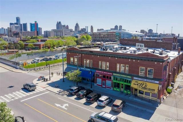 An aerial view of a building with a lot of cars parked in front of it.