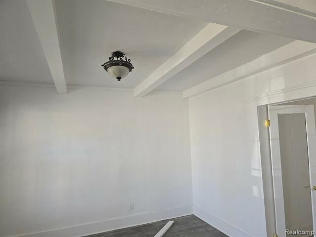 An empty room with white walls and a ceiling fan.