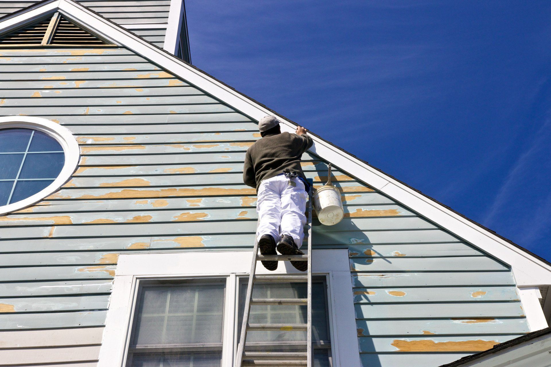 Man Painting Exterior Of The House | Kansas City, MO | 4 Seasons Painting LLC