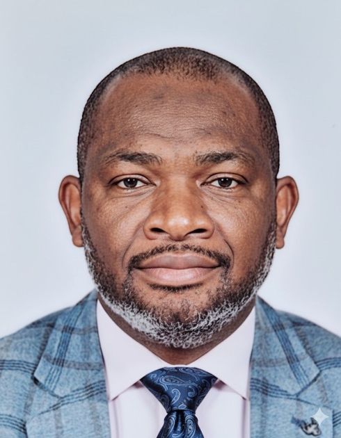 Smiling man with glasses and bald head wearing a suit with 