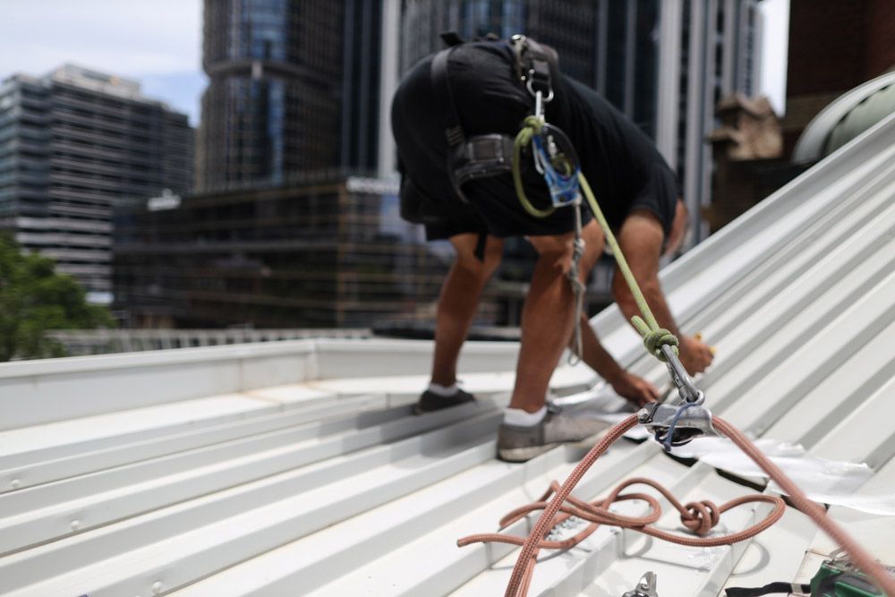 Construction Worker on a Harness Fixing Roof — Roofer in Orange, NSW