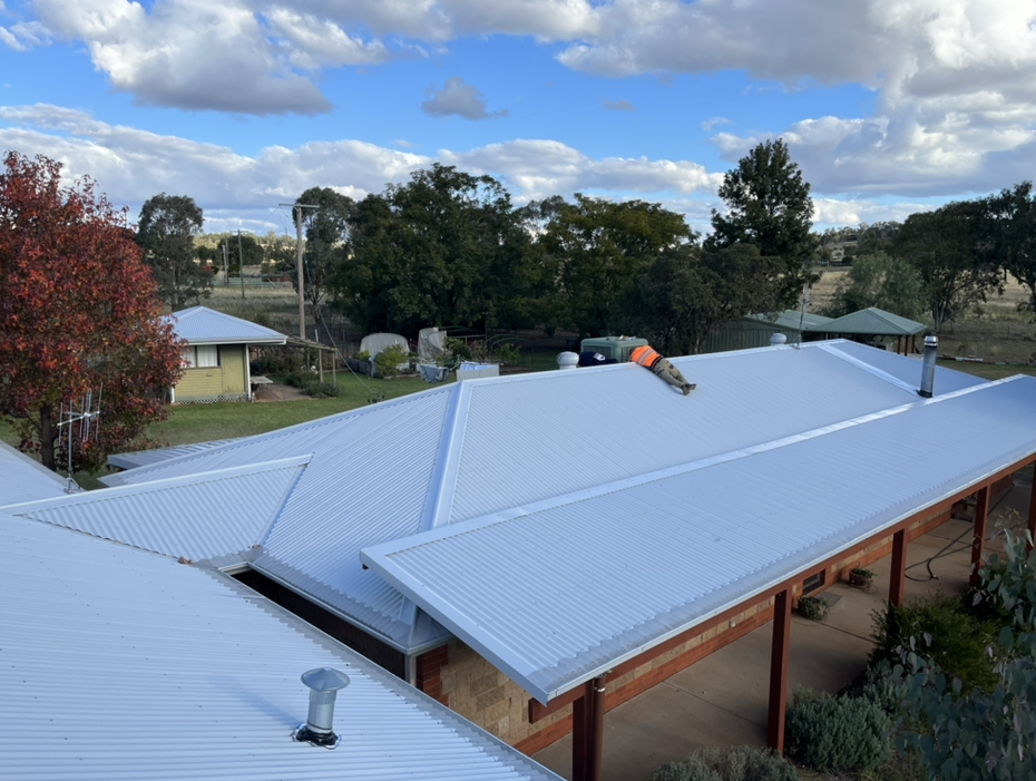 Workers Repairing Metal Sheet Roof — Roofer in Orange, NSW