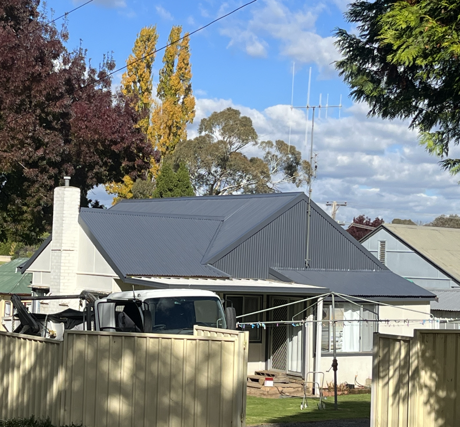 Happy Roofing Craftsman at Work in Spring — Roofer in Parkes, NSW