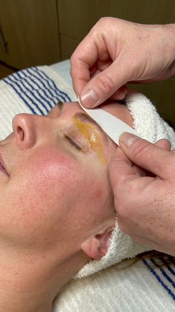 A woman is getting a facial treatment at a spa.
