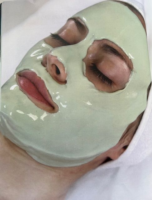 A woman is wearing a green mask on her face