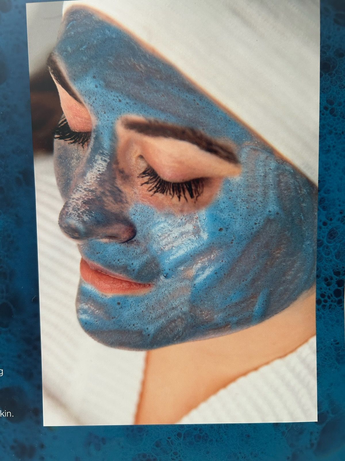 A woman is wearing a blue mask on her face