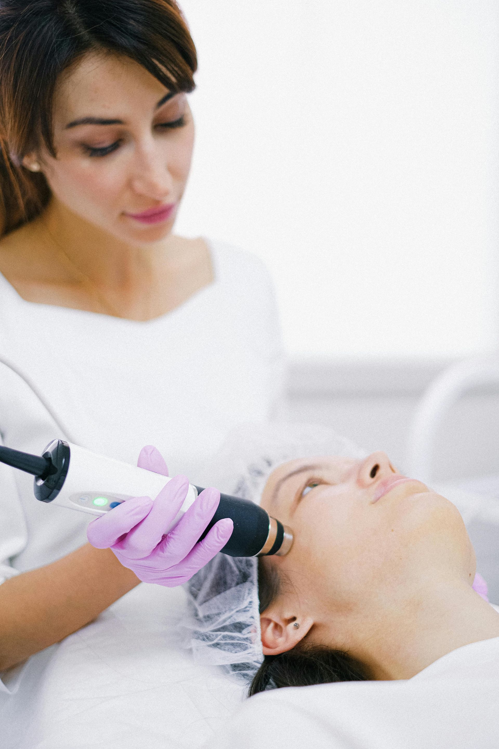 A woman is getting a facial treatment at a beauty salon.