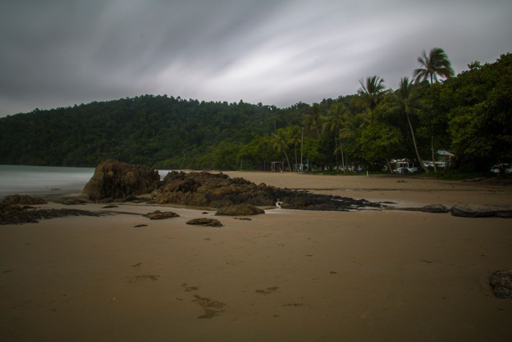a Lush Green Field With Mountains in the Background on a Sunny Day — Innisfail Glass & Aluminium In Innisfail, QLD