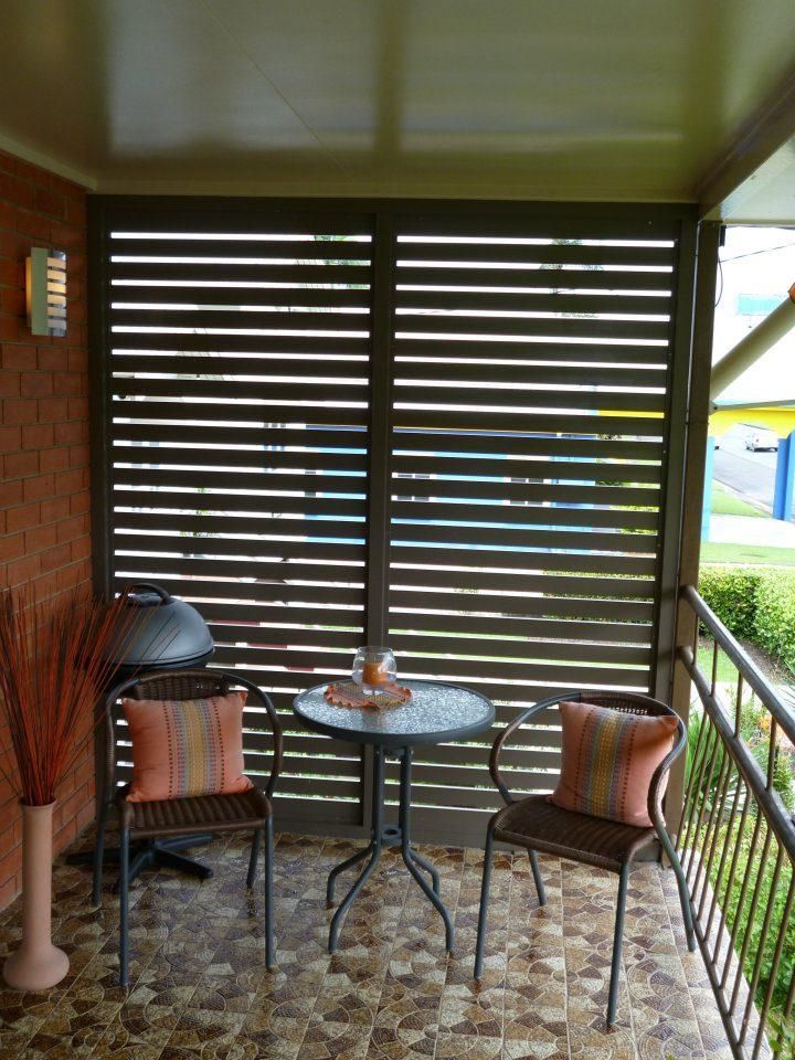 a Balcony With a Table and Chairs and a Grill — Accessories in Cassowary Coast, QLD