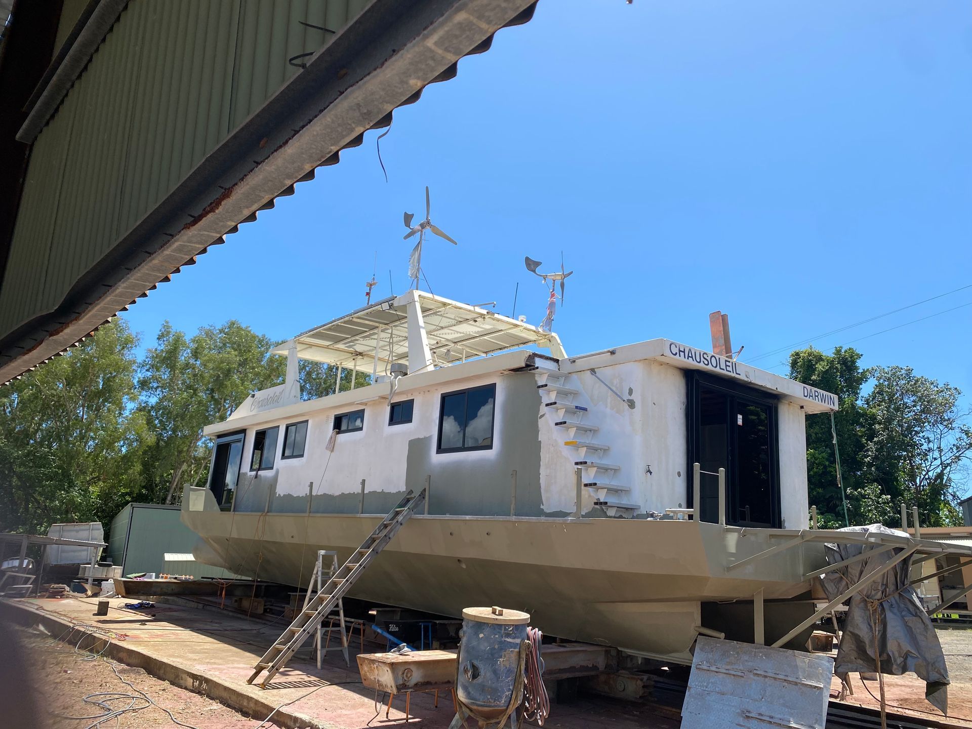 A large boat is sitting on the ground under a roof — Innisfail Glass & Aluminium In Innisfail, QLD