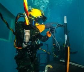 scuba diver with full gear under the ocean