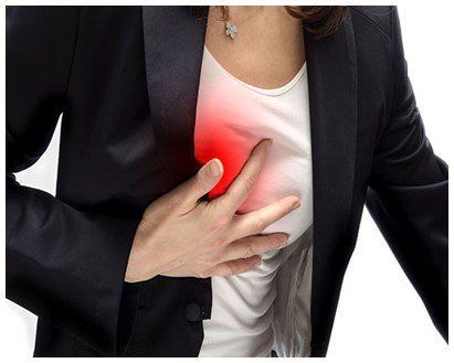 woman holding chest in pain