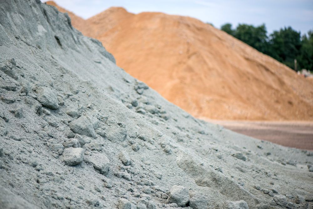 There Are Many Piles of Dirt and Sand in The Background — BVN Landscape & Steel Supplies in St Georges Basin, NSW