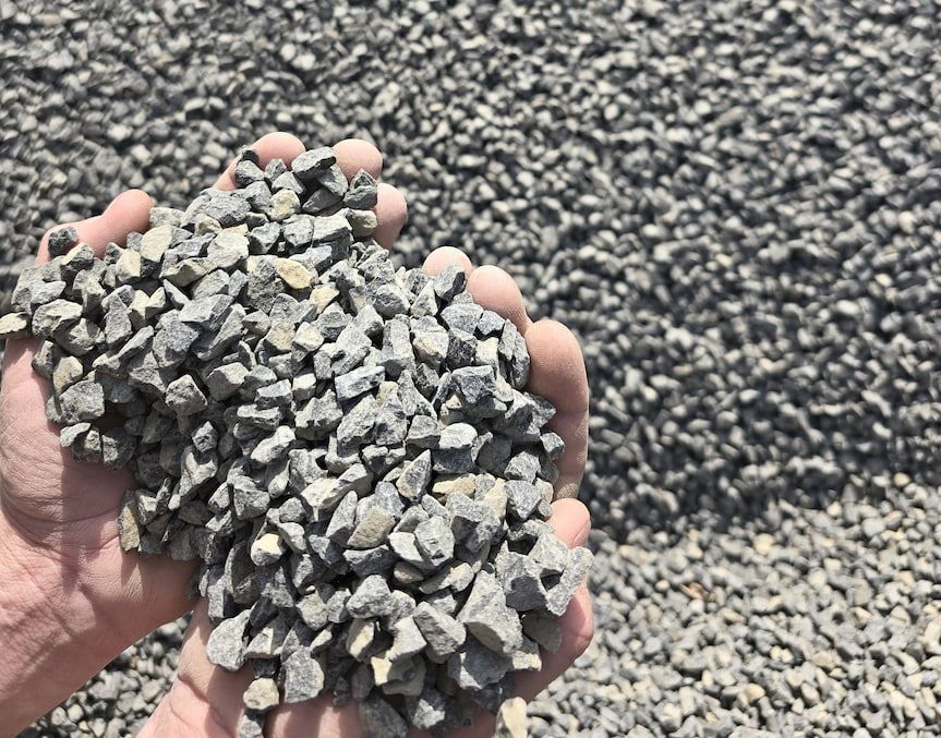 A Person Is Holding a Pile of Gravel in Their Hands — BVN Landscape & Steel Supplies in Vincentia, NSW