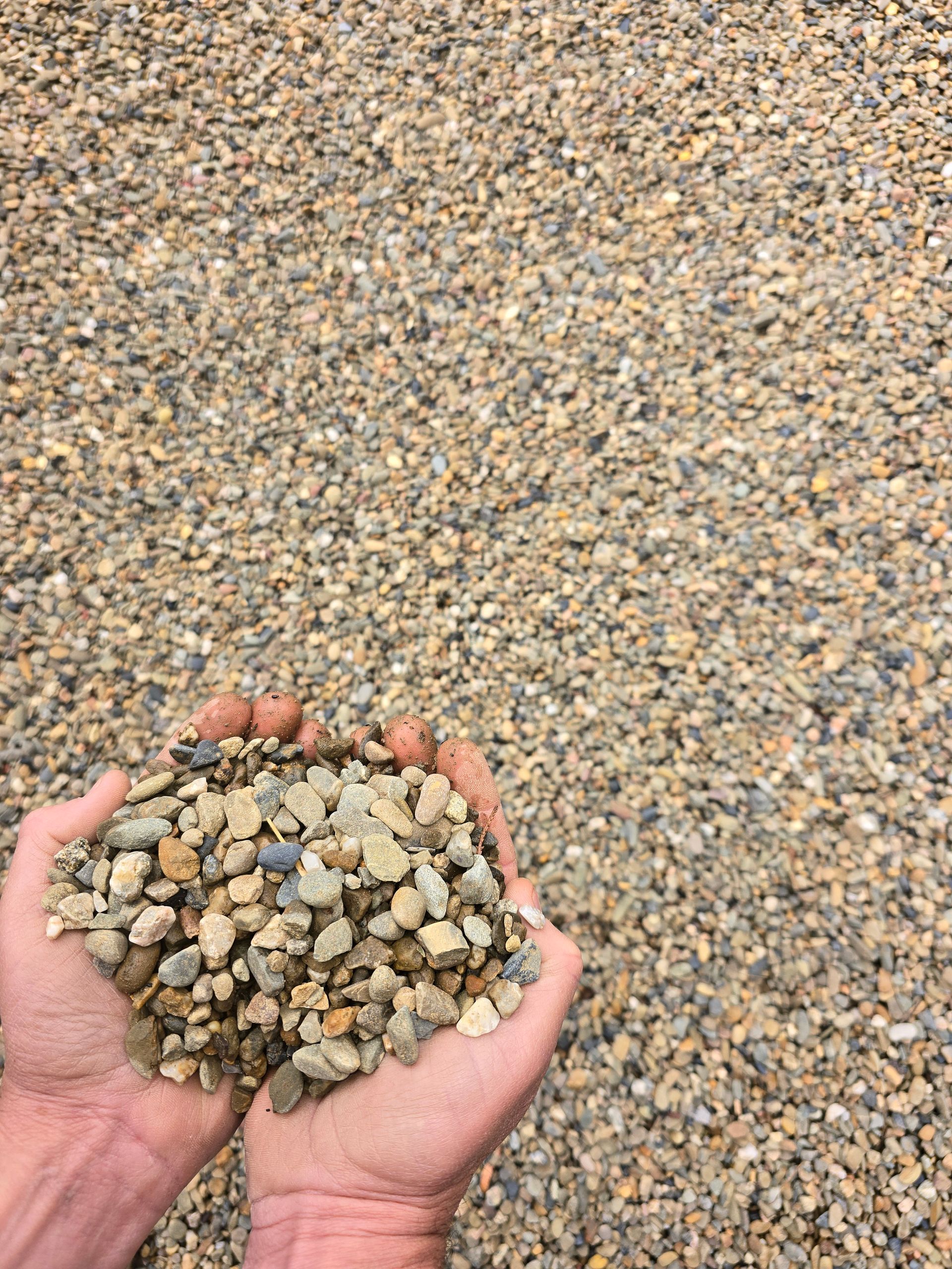 Hands Holding a Pile of Small, Light-colored Gravel — BVN Landscape & Steel Supplies in St Georges Basin, NSW